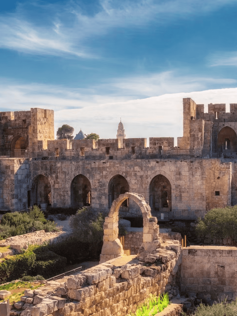 Ancient stone fortress ruins with historical architecture and scenic sky background.