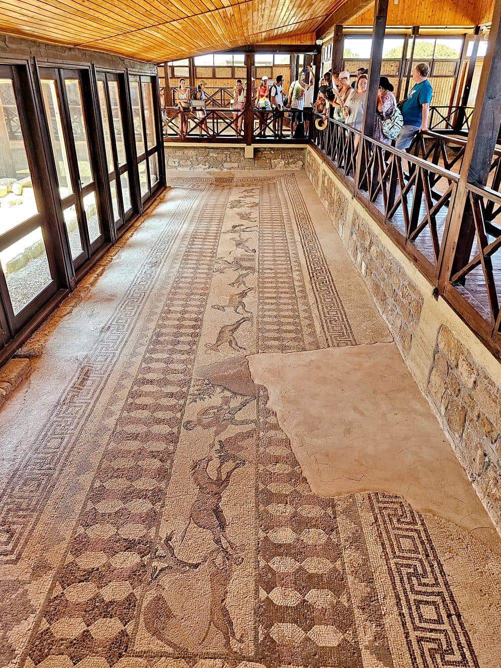 Ancient Roman mosaic floor with colorful geometric and animal patterns, displayed at QuestForDirections.