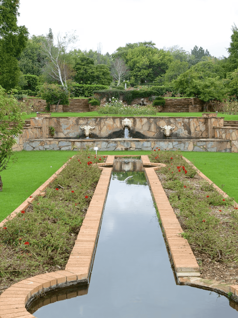 Serene garden with water feature and lush greenery at QuestForDirections.