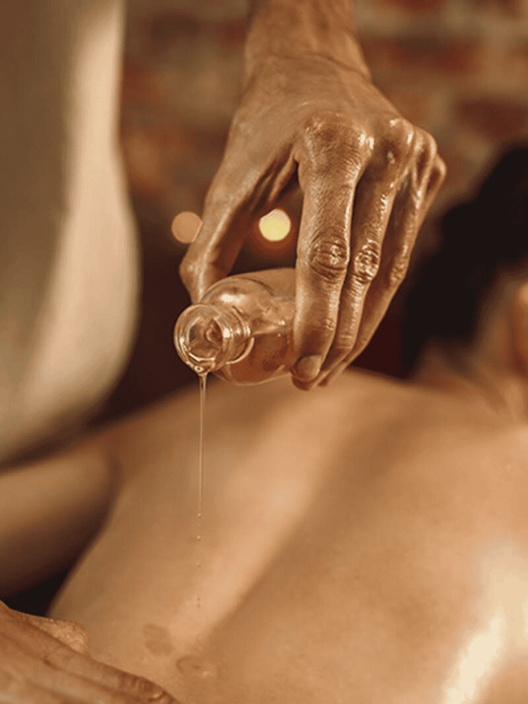 Relaxing massage therapy with warm oil treatment for muscle relaxation and stress relief.