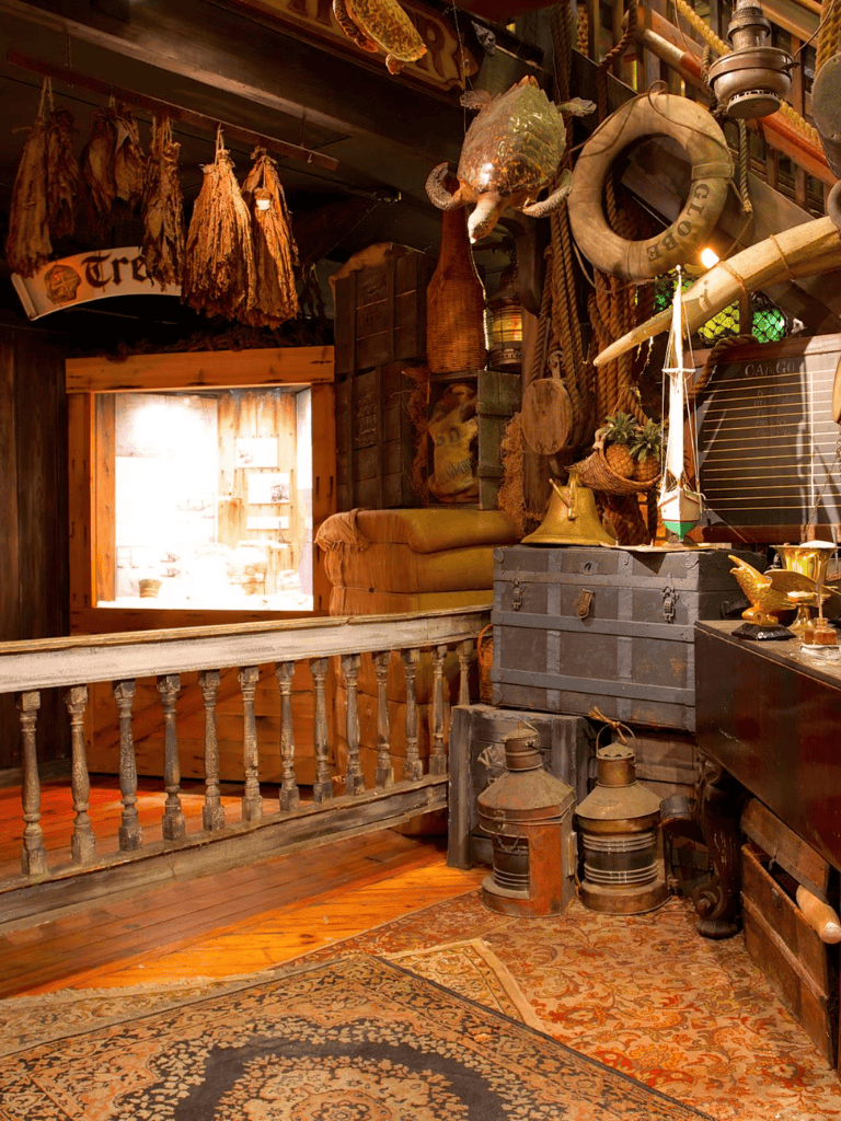 Rustic vintage interior with nautical decor and antiques inside cozy cabin setting.