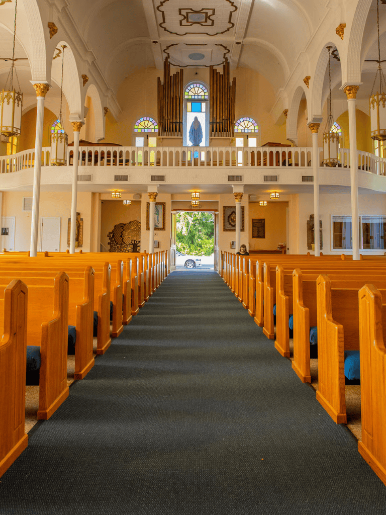 Peaceful church interior with wooden pews, stained glass windows, and altar decor for spiritual guidance and community worship.