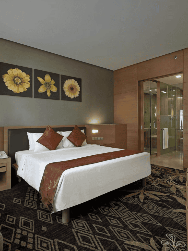 Comfortable hotel bedroom with modern decor and en-suite bathroom.