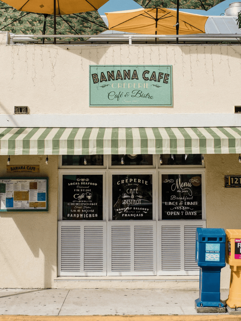 Banana Cafe exterior with French bistro style signage and outdoor seating for breakfast and lunch.