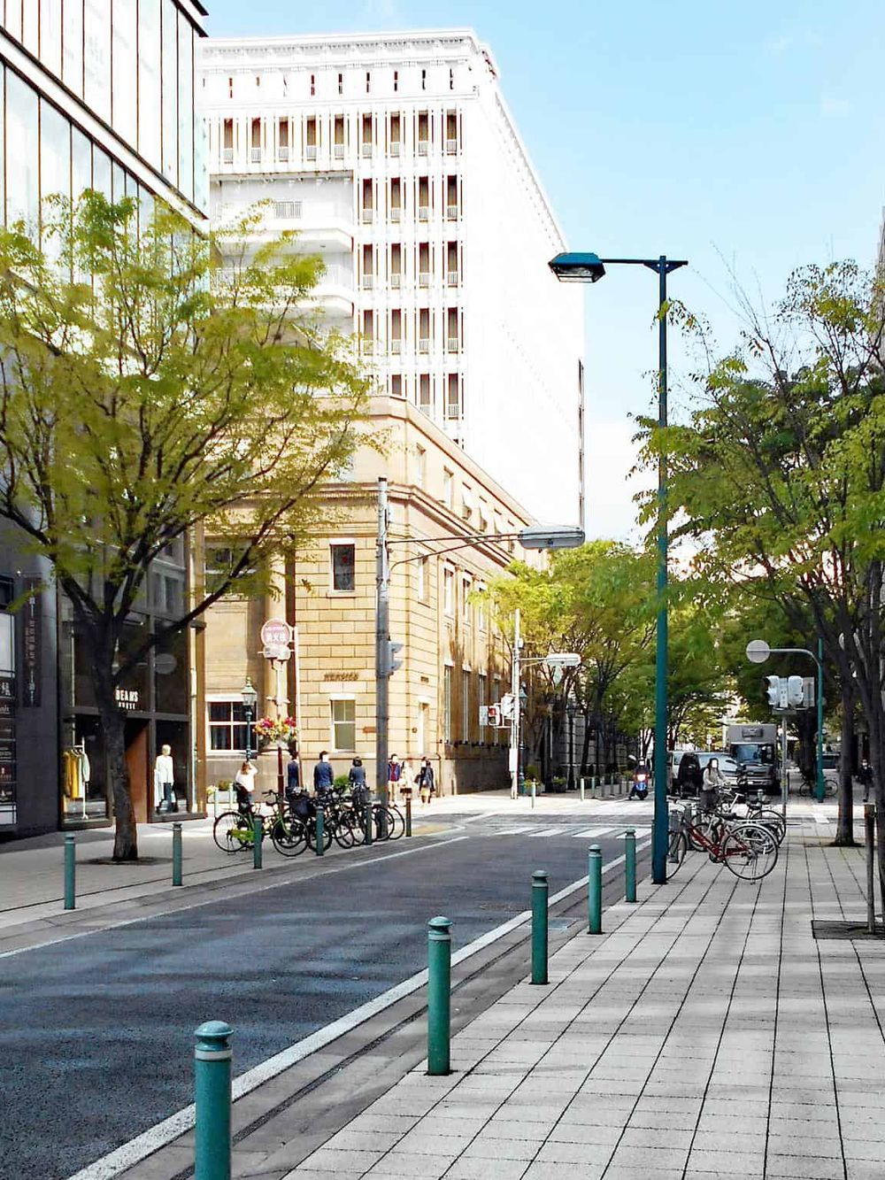 Versatile city street scene showcasing bike racks, trees, and architecture, perfect for urban navigation and travel directions.