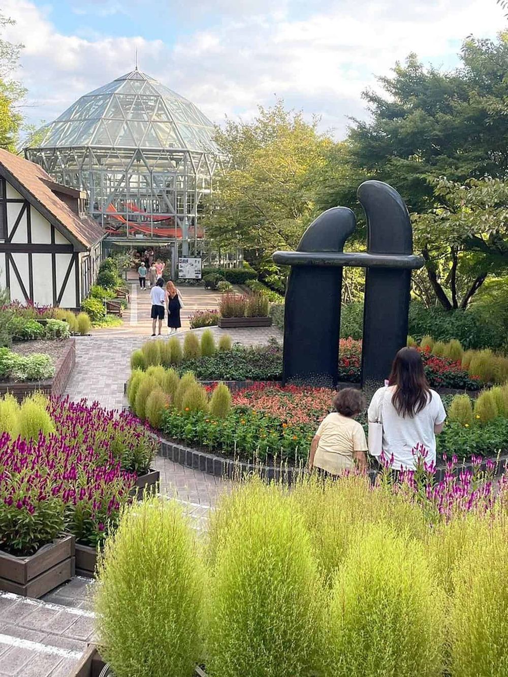 Modern glass conservatory with water slides at Quest for Directions botanical garden.