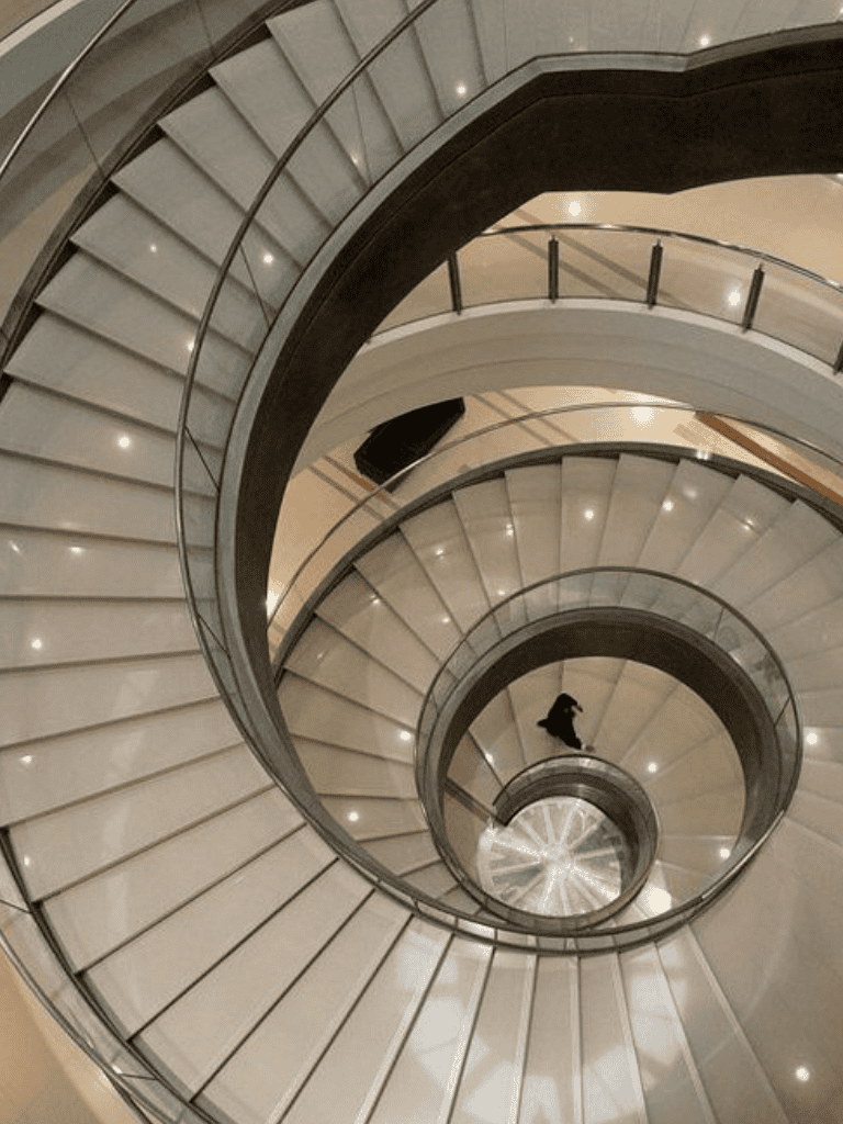 Spiral staircase interior view in a modern building, elegant design, smooth curves.