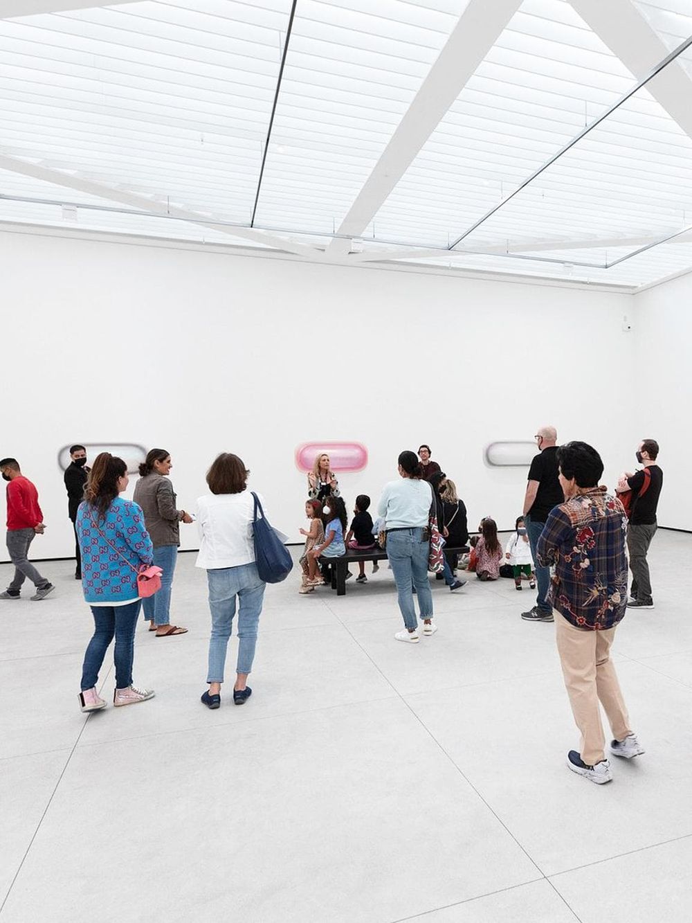 Modern art museum visitors engaging with contemporary exhibits, diverse group exploring innovative art installations.