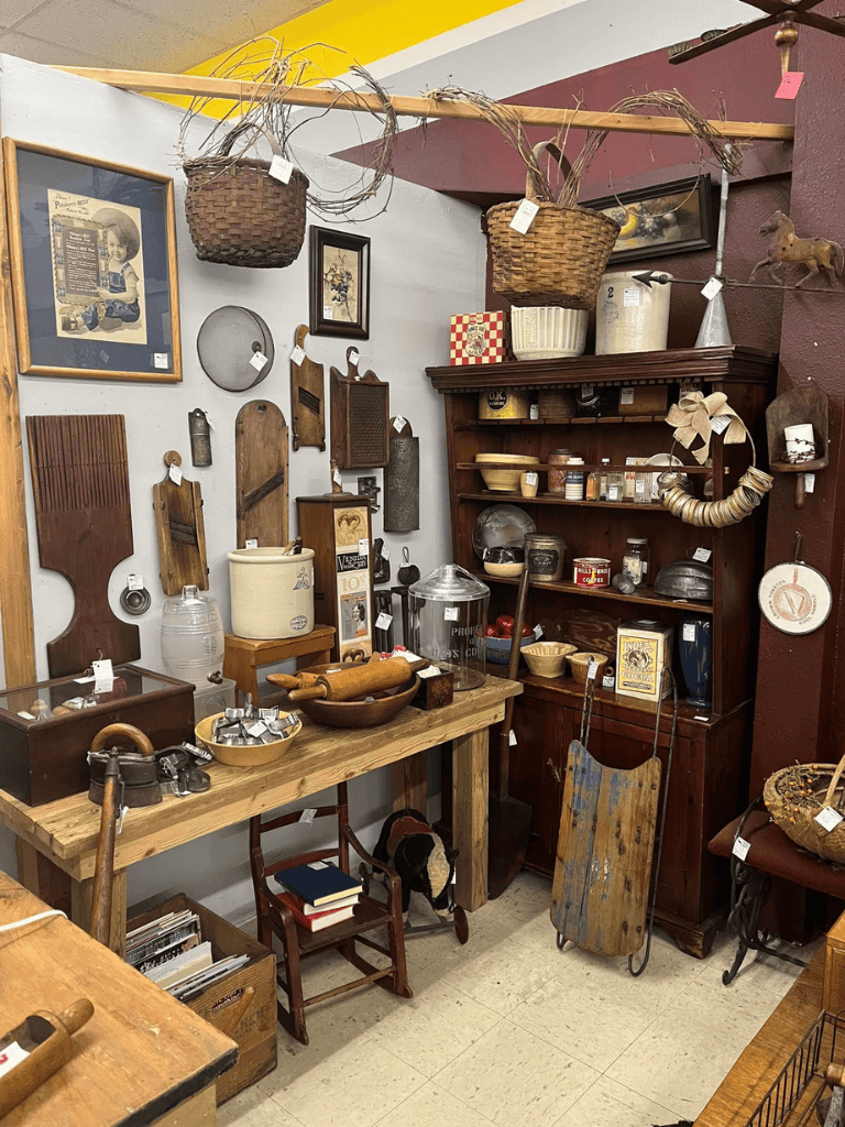 Antique vintage kitchen items and decor in an eclectic thrift store display.
