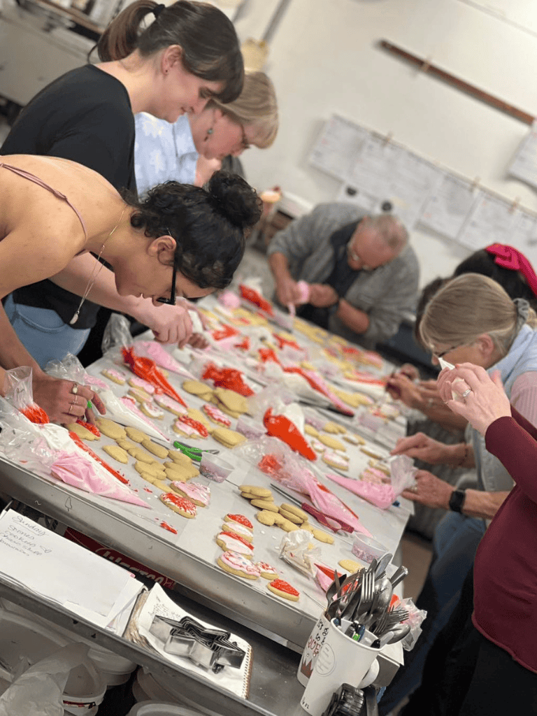 Decorating Valentine's Day cookies at a baking workshop.