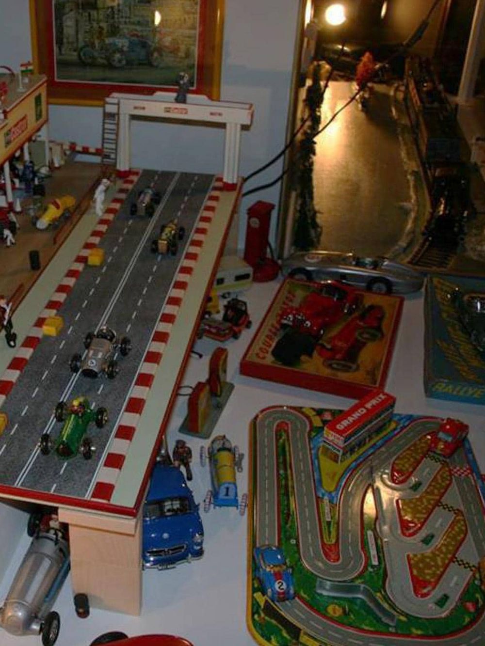 Vintage toy race car track with miniature cars and accessories, perfect for children’s racing and imaginative play.