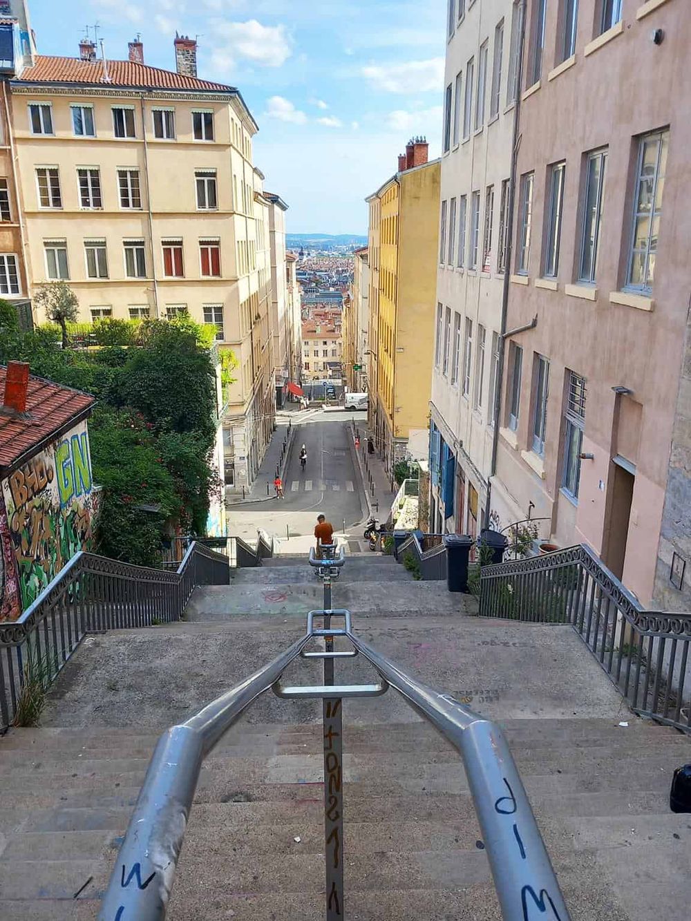 Breathtaking city view from staircase in Lisbon, Portugal showcasing vibrant streets and historic architecture.