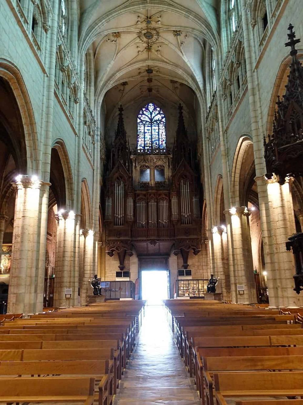 Stunning interior of a historic cathedral with soaring ceilings and intricate stained glass windows.