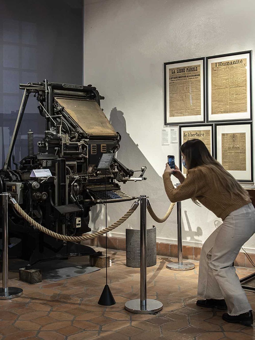 Antique printing press at a museum exhibit, showcasing historical printing technology.