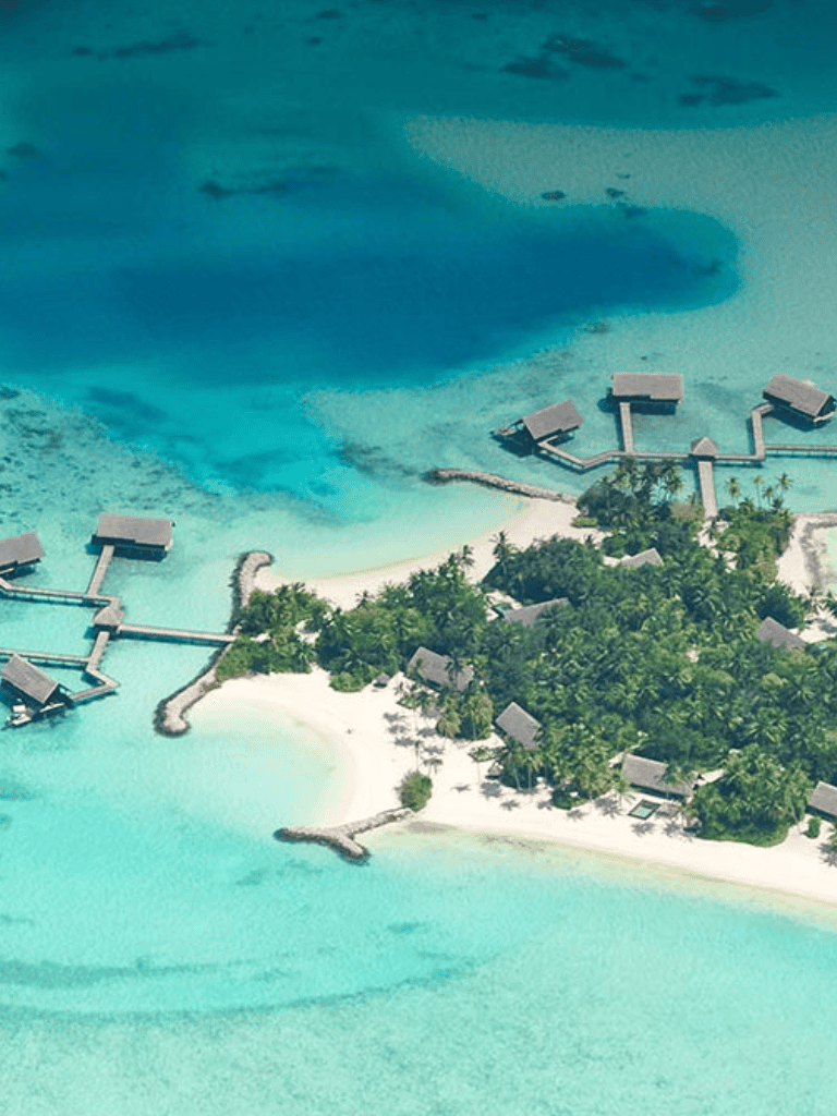 Overwater Bungalows in Tropical Island Resort, clear blue ocean, white sandy beaches, lush greenery, perfect vacation destination.