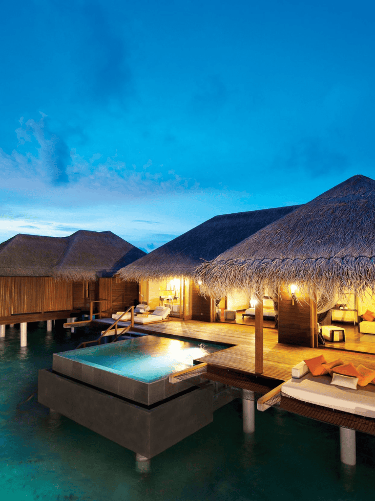 Overwater bungalow with private pool at sunset, tropical paradise vacation, luxury travel, overwater resorts, serene escape.