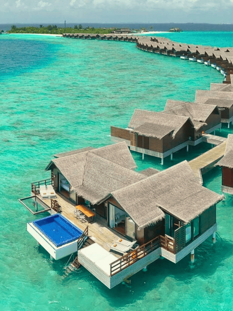 Secluded overwater bungalow with private pool on turquoise ocean.