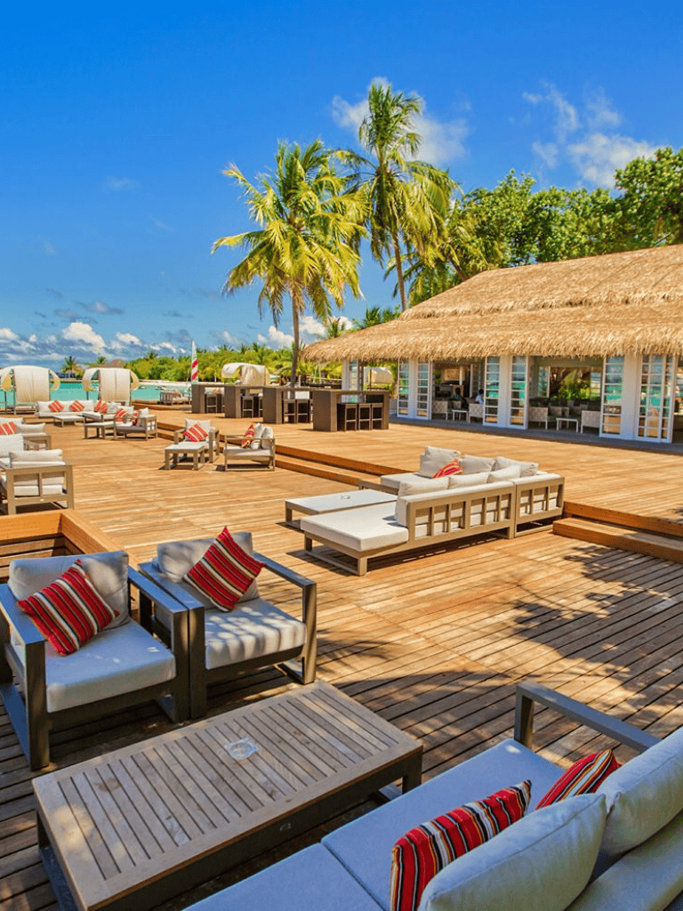 Luxurious tropical beach resort with palm trees and ocean views, perfect for relaxation and vacation.