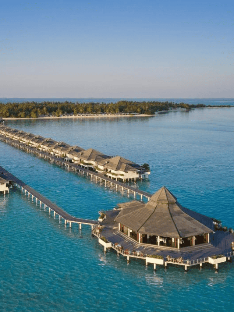 Overwater Bungalows at a tropical island resort with clear blue waters and a serene atmosphere.