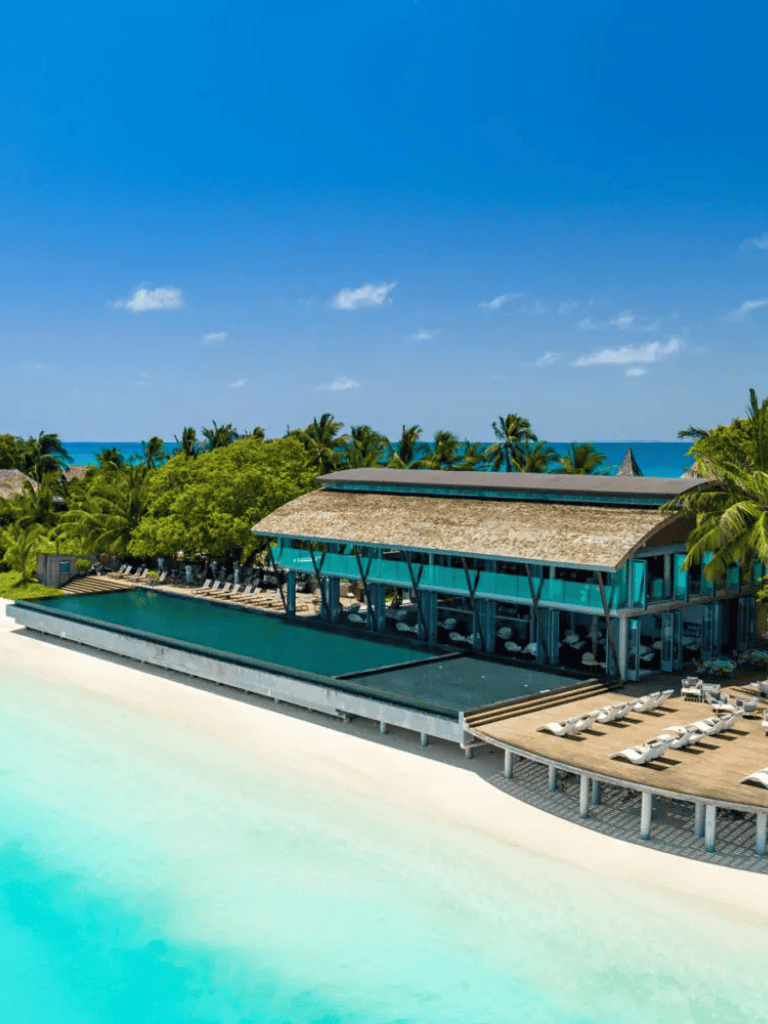 Luxurious tropical beachfront resort with infinity pool and ocean view.