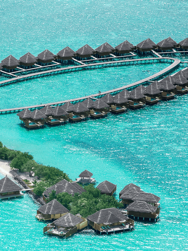 Overwater bungalows at a tropical resort with turquoise waters.