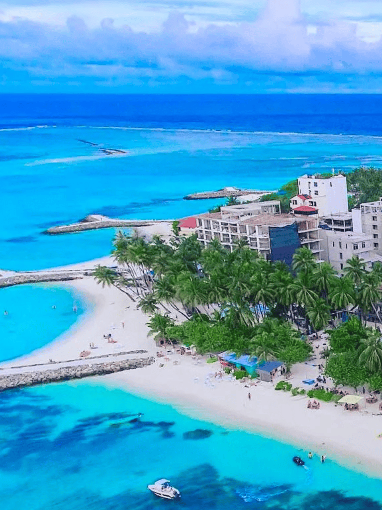 Turquoise beach with luxury resorts and palm trees, vibrant Caribbean seaside destination.