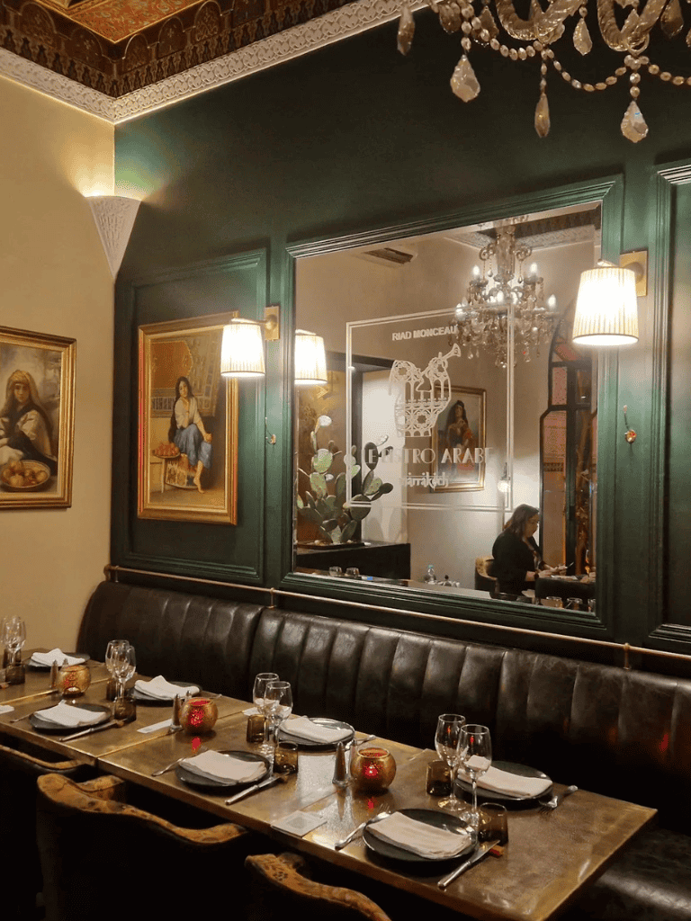 Elegant Moroccan restaurant interior with traditional decor and candlelit table setting.