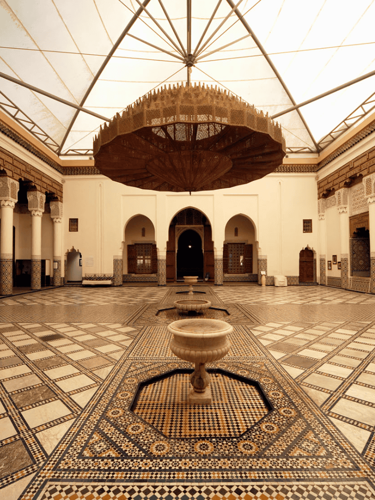 Intricate Moroccan-style interior with fountains, arches, and mosaic tile flooring.