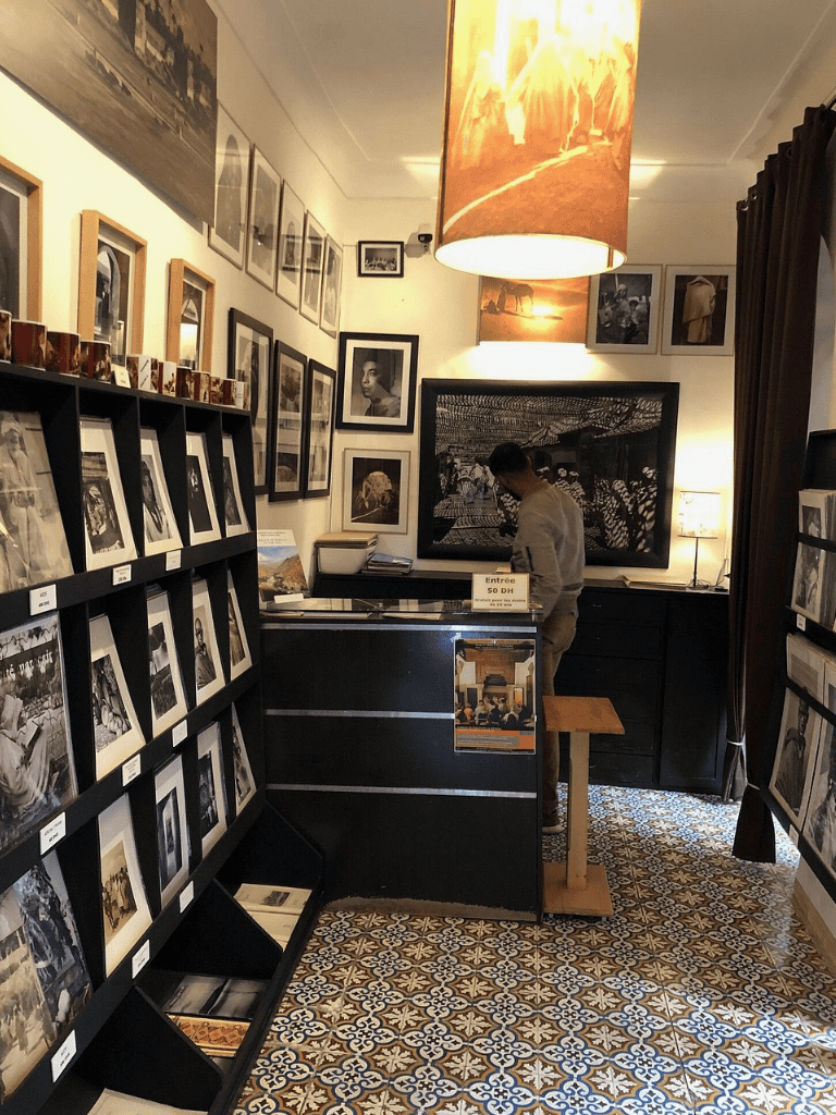 Vintage black-and-white photographs displayed in a cozy art gallery or photography shop, perfect for art lovers and collectors.