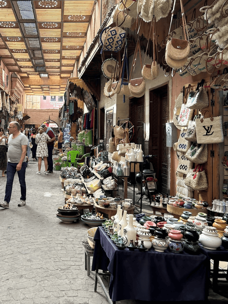 Colorful Moroccan marketplace with ceramics, woven bags, and handcrafted souvenirs for travel enthusiasts.