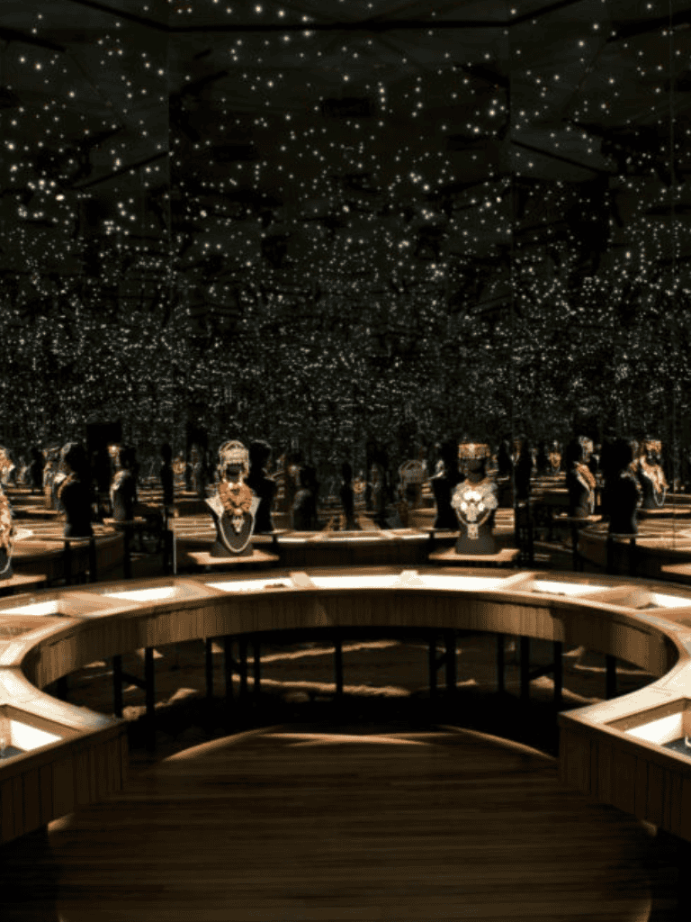 Elegant jewelry display in a luxury showroom with starry ceiling lighting.