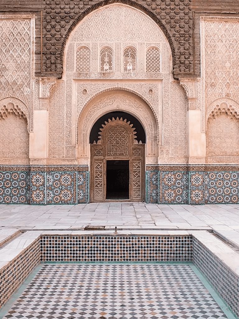 Intricate Moroccan architecture with arched doorways and colorful tile work in historic Dar el Makhzen palace.