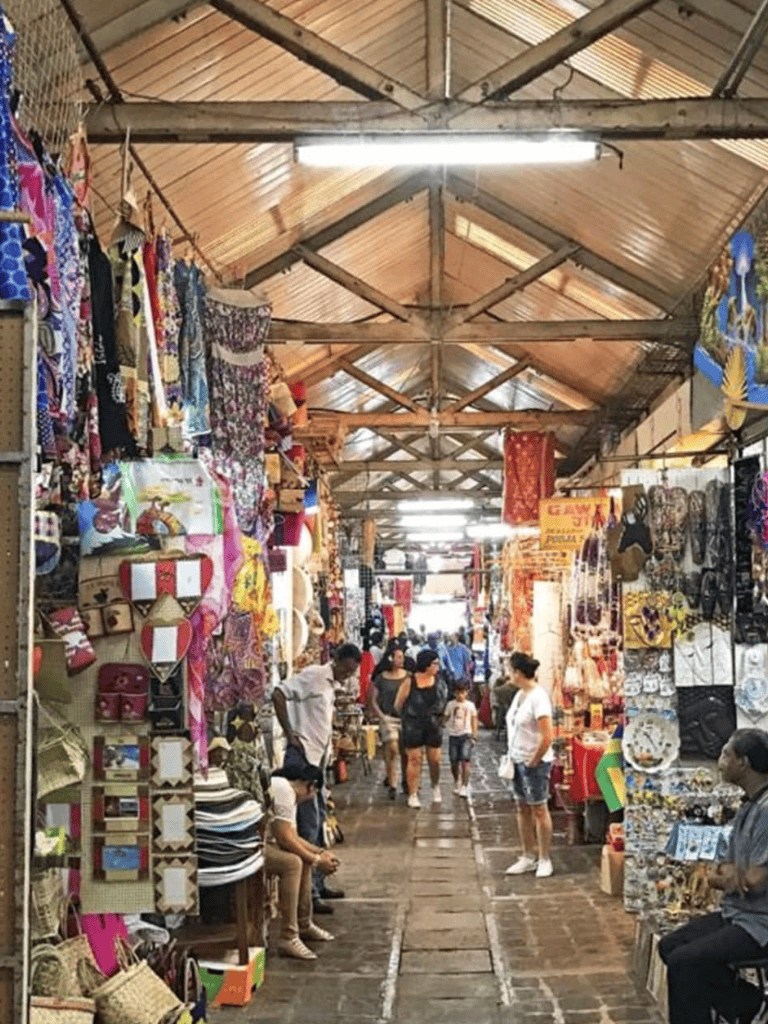 Colorful indoor market showcasing local crafts, clothing, and souvenirs in a vibrant shopping environment.