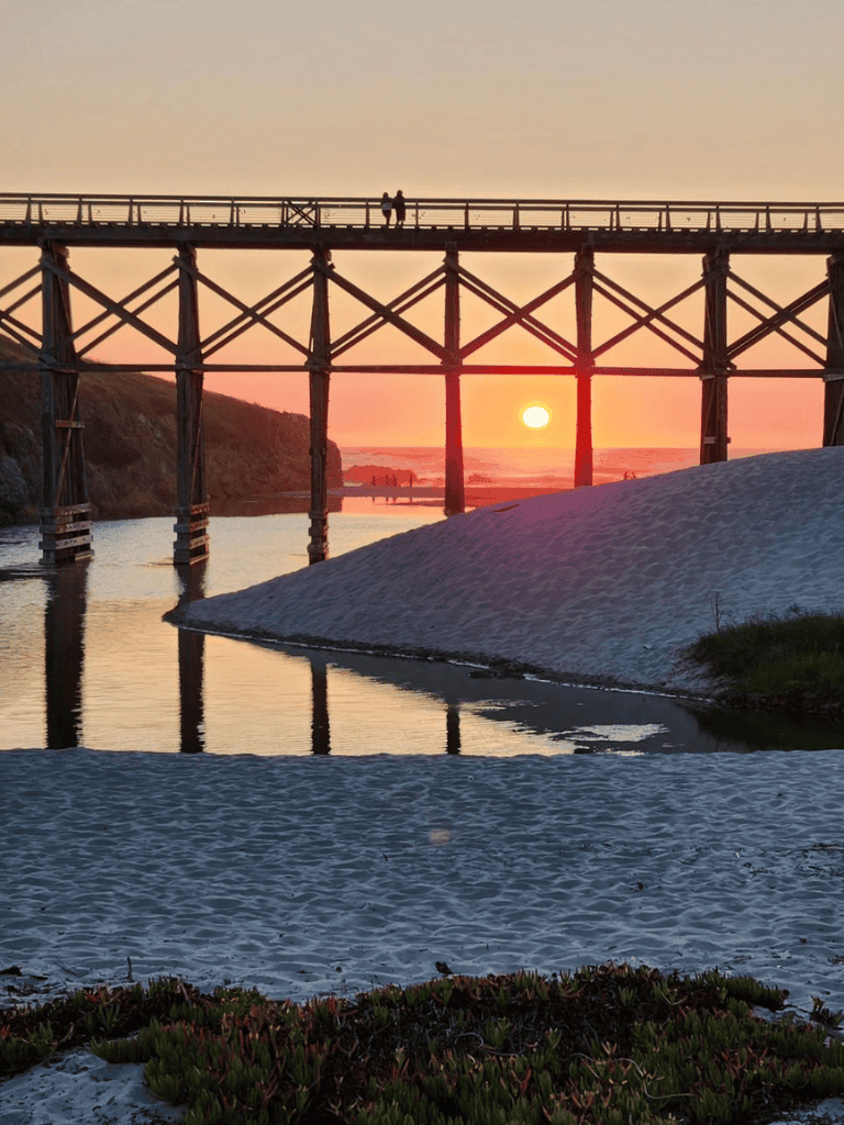Sunset over historic Santa Cruz Wharf at dusk, capturing scenic coastal views and peaceful water reflections.