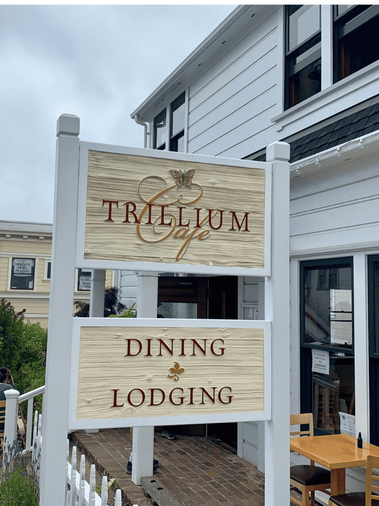 Trillium Cafe dining and lodging sign at QuestForDirections, cozy outdoor restaurant.
