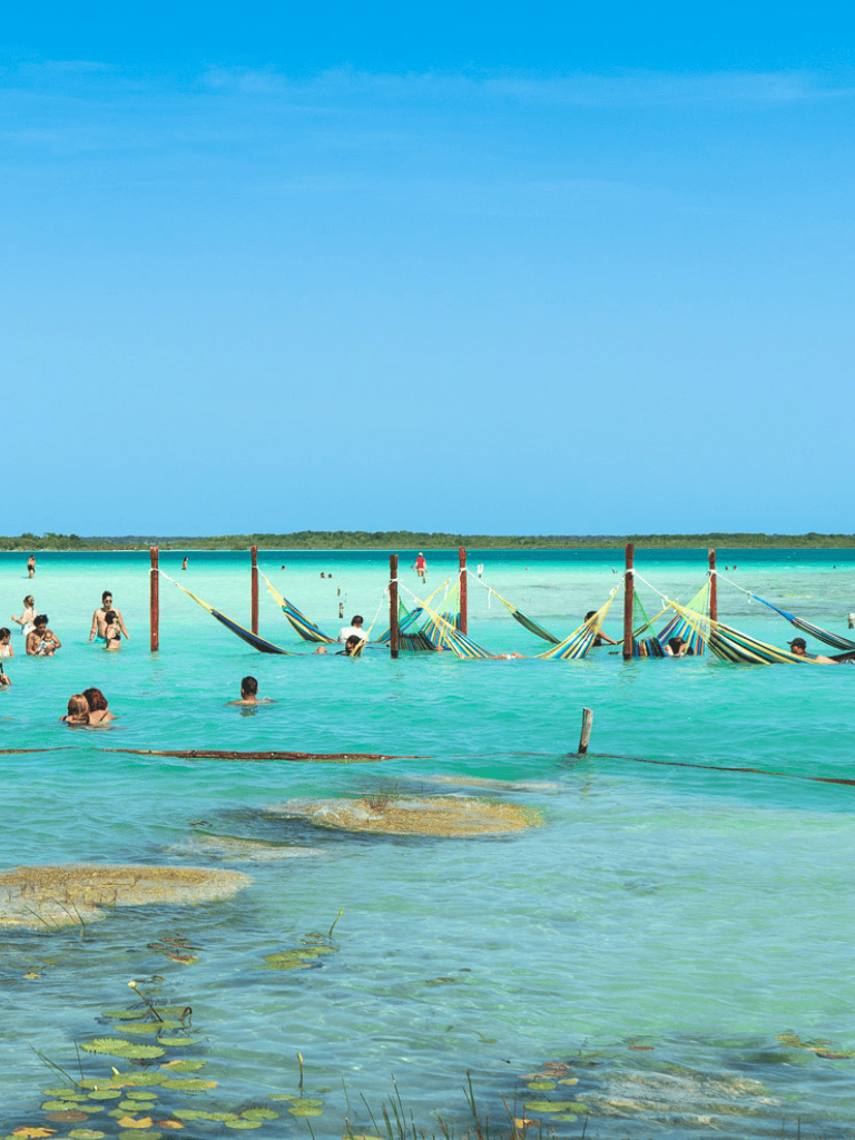 Relaxing beach scene with hammocks over turquoise water, perfect for beach vacations and tropical getaways.