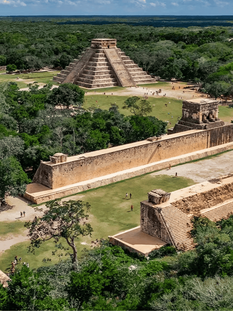 Ancient Mayan pyramid at Chichen Itza surrounded by lush greenery and forest landscape.