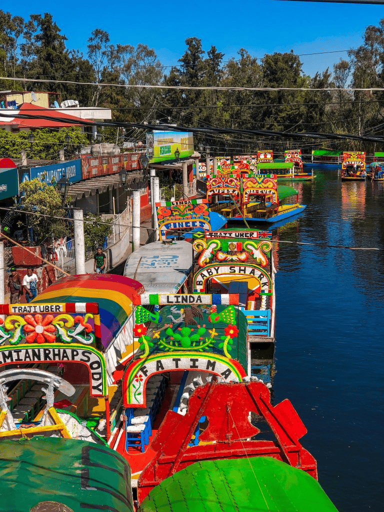 Colorful boat ride at a lively waterfront in Mexico, popular tourist destination.
