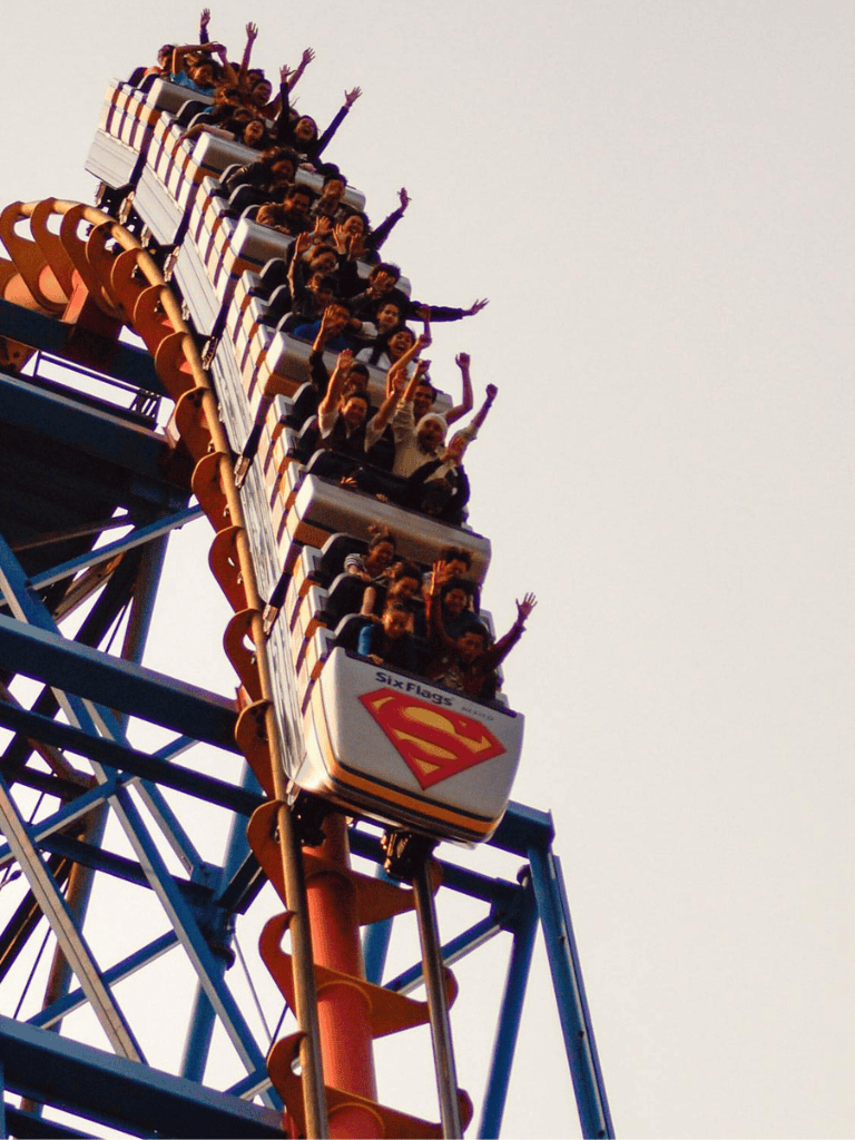 Thrilling roller coaster ride at amusement park with excited visitors, high speeds, and roller coaster safety features.