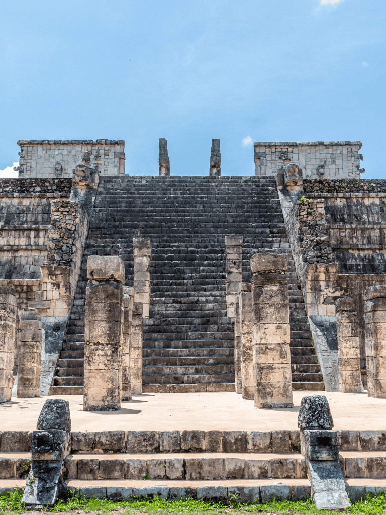 Ancient Mayan pyramid with stone stairs and ruins, archaeological site in Mexico.