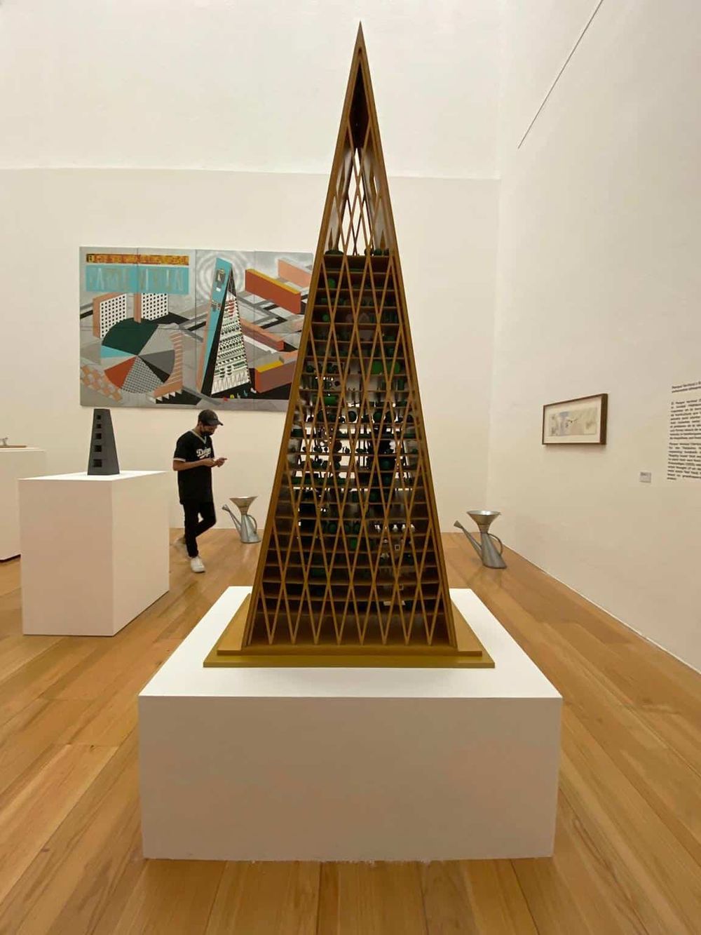 1. Modern wooden pyramid sculpture at an art gallery.