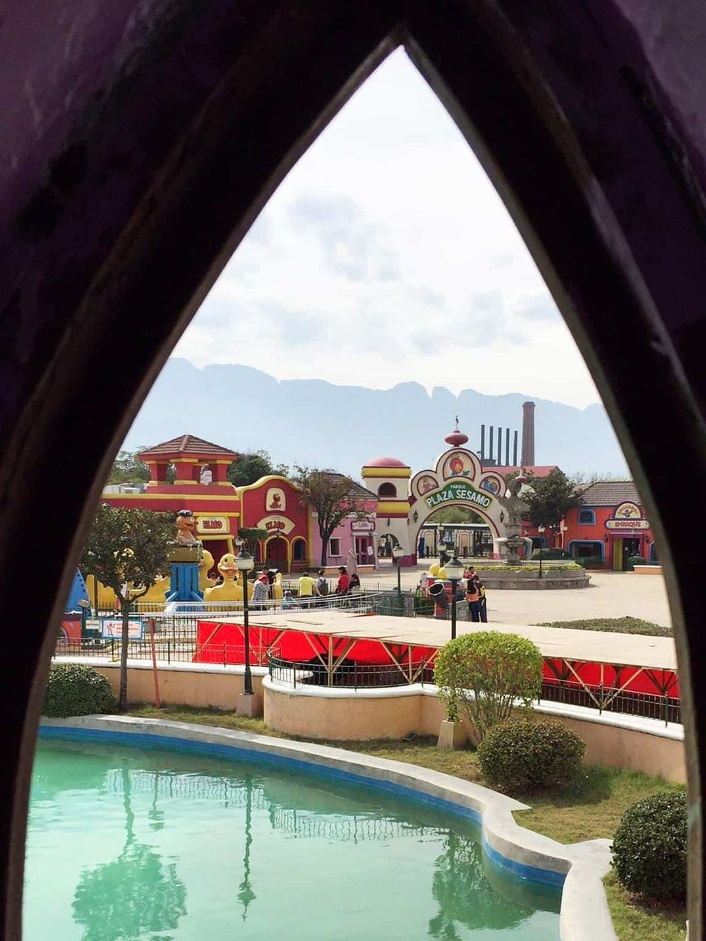Colorful amusement park view through a window arch at QuestForDirections.