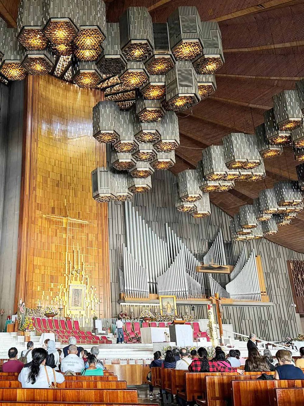 Elevator lights and warm wood interior in a church sanctuary.