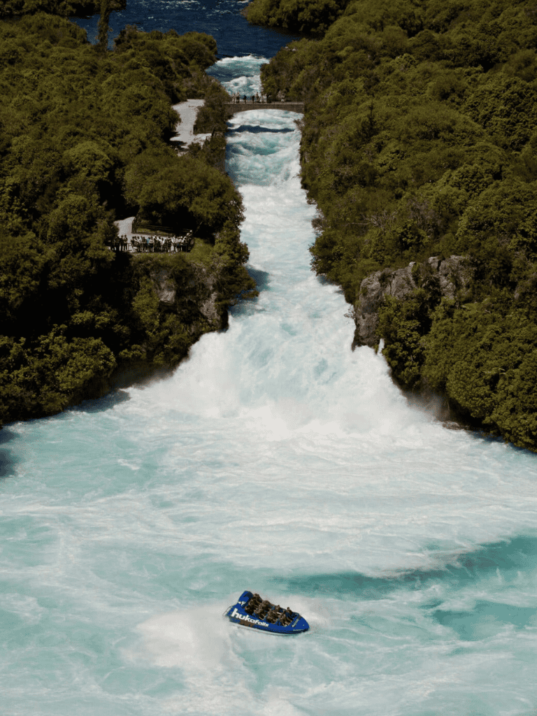 Thrilling white water rafting adventure on powerful river with lush green landscape.