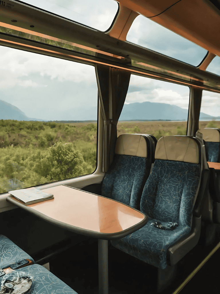 Scenic view from a bus window overlooking lush greenery and mountains, perfect for travel and adventure photography.