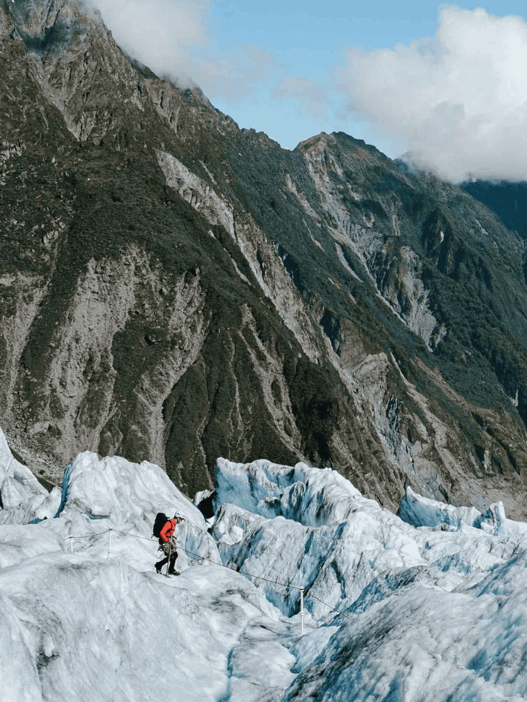 Glacier trek in the Andes mountains with a guide, adventure travel, and scenic mountain views.