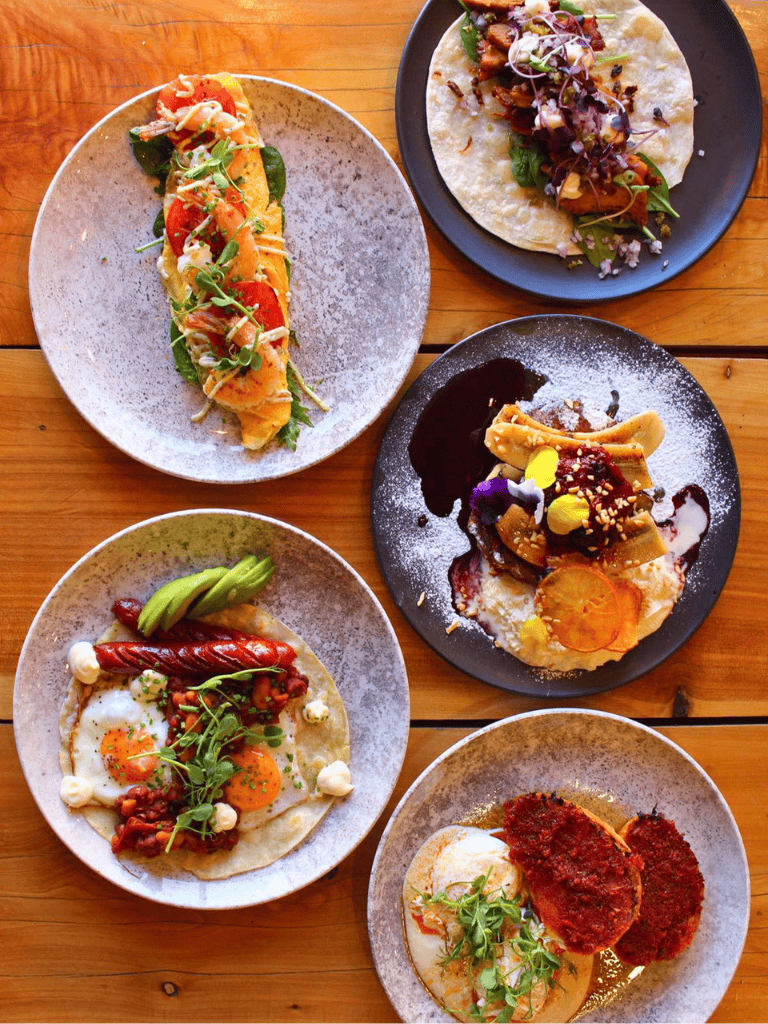 Colorful gourmet dishes served on stylish plates at QuestForDirections restaurant in a cozy setting.