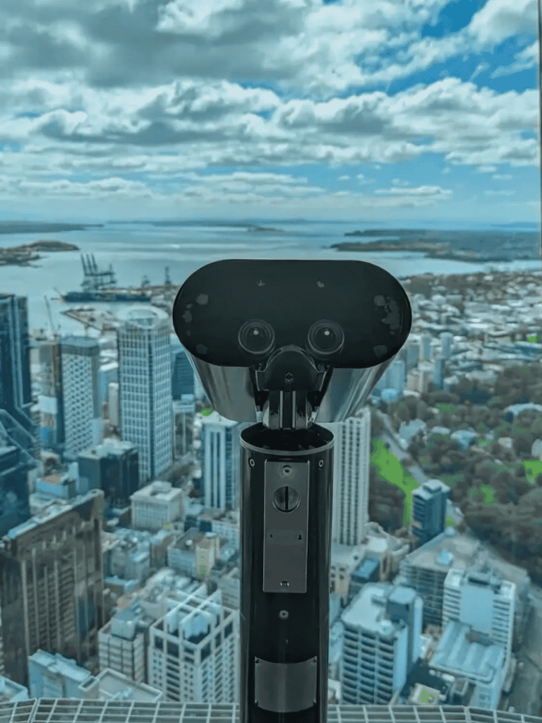 Spectacular city view from the QuestForDirections observation deck with telescope on skyscraper rooftop.