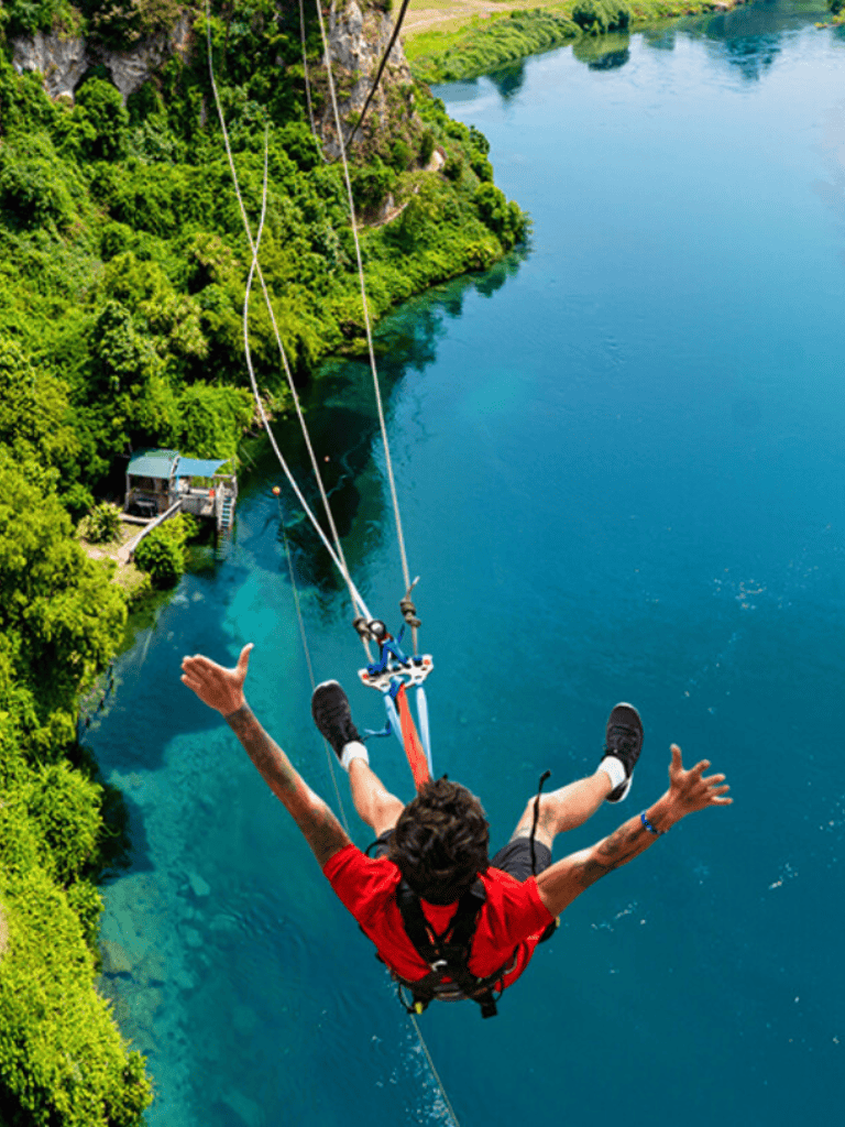 Thrilling zip line adventure over lush green landscape and river canyon.