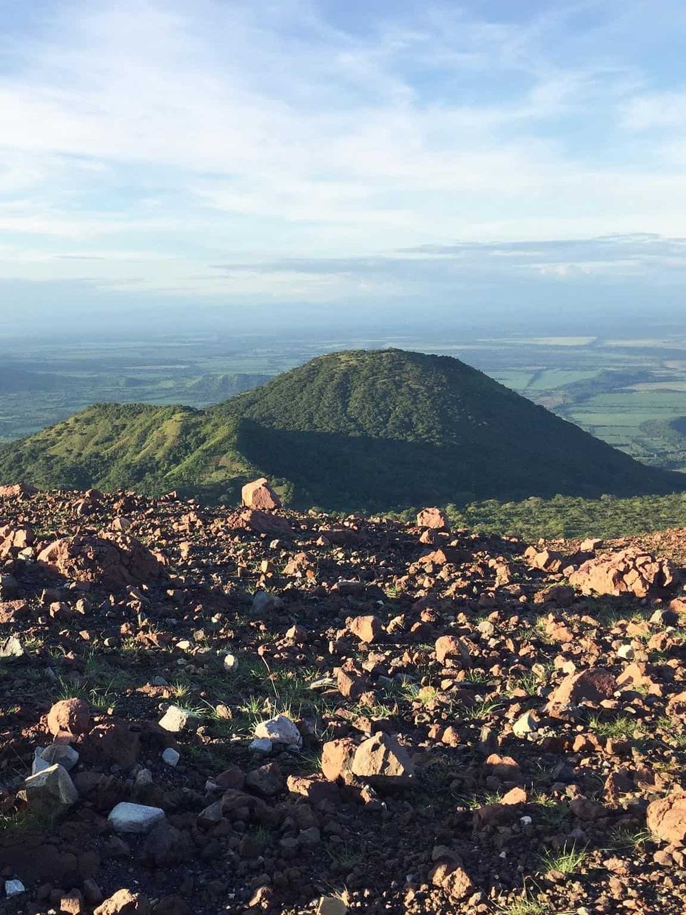 Striking mountain view with rocky foreground and expansive landscape, perfect for adventure travel and outdoor exploration.